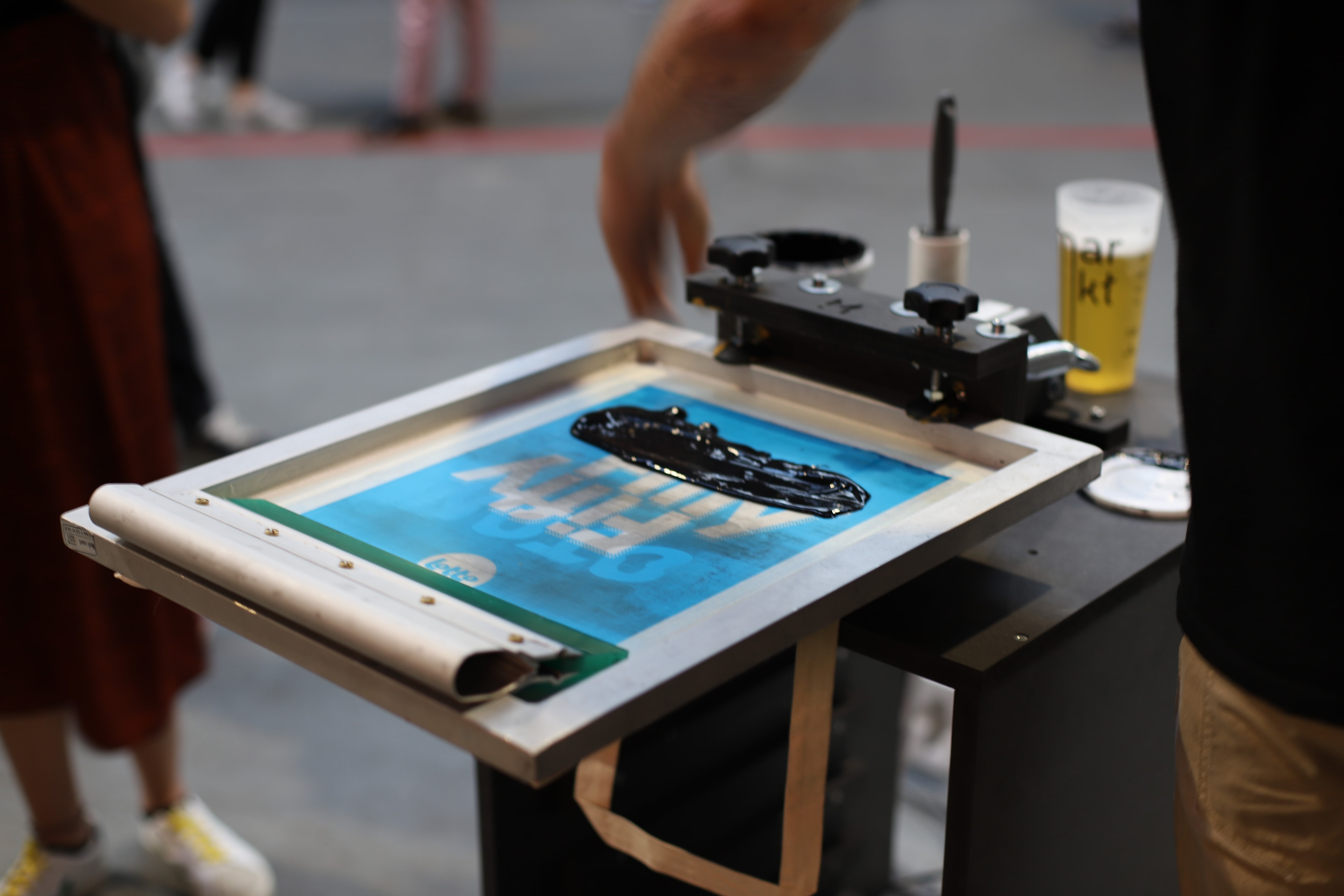 A mekanika monocrhom screen printing press being used during an event