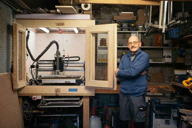 Pierre Lohay in his workshop standing next to his Mekanika Pro