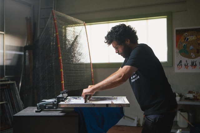 Bichel printing in his workshop with the mekanika screen printing press