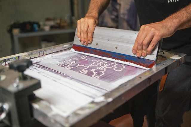 Focus on Bichel's hands while printing t shirts