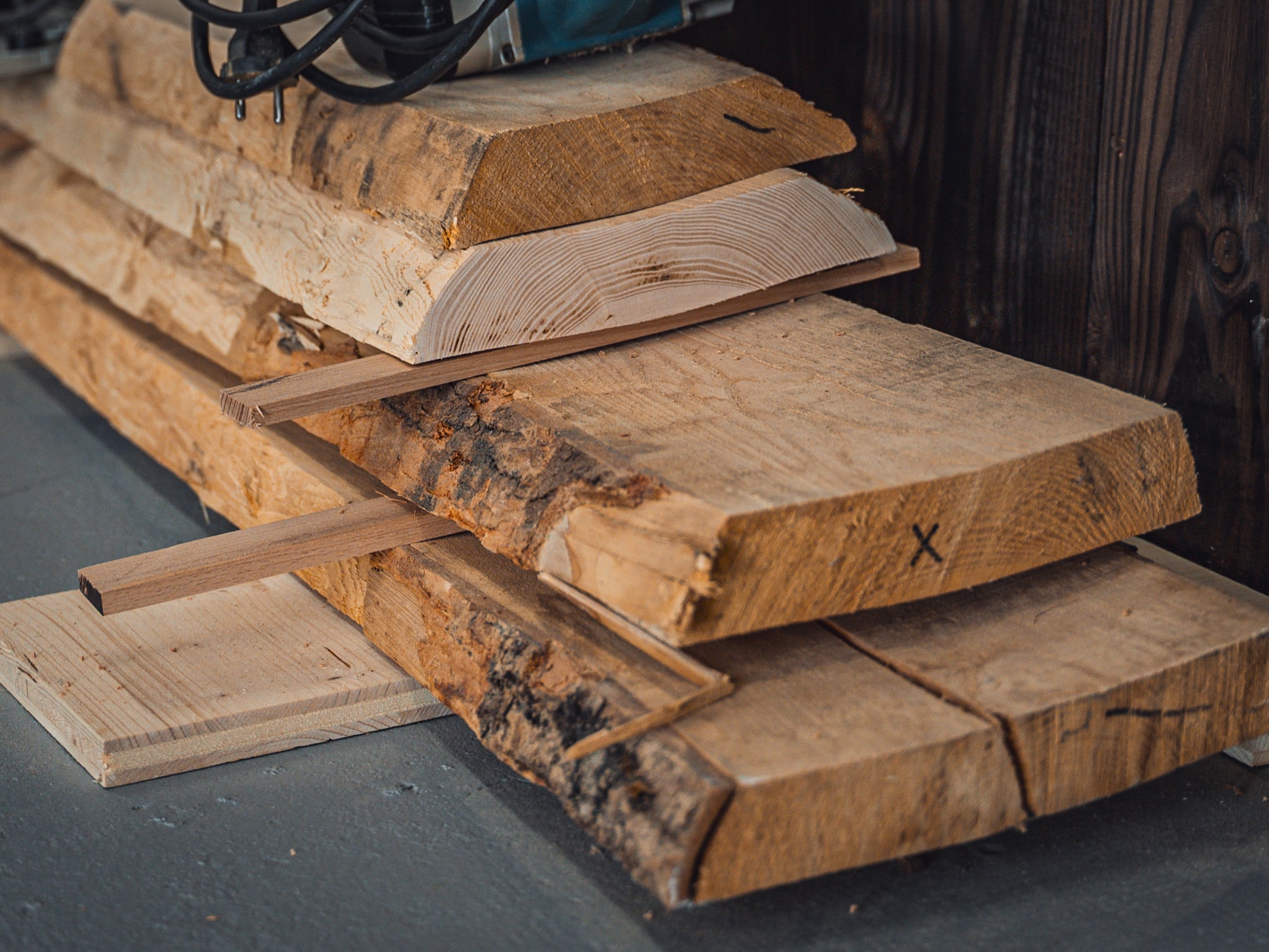 Raw solid wood slabs stocked in a wood worker's workshop