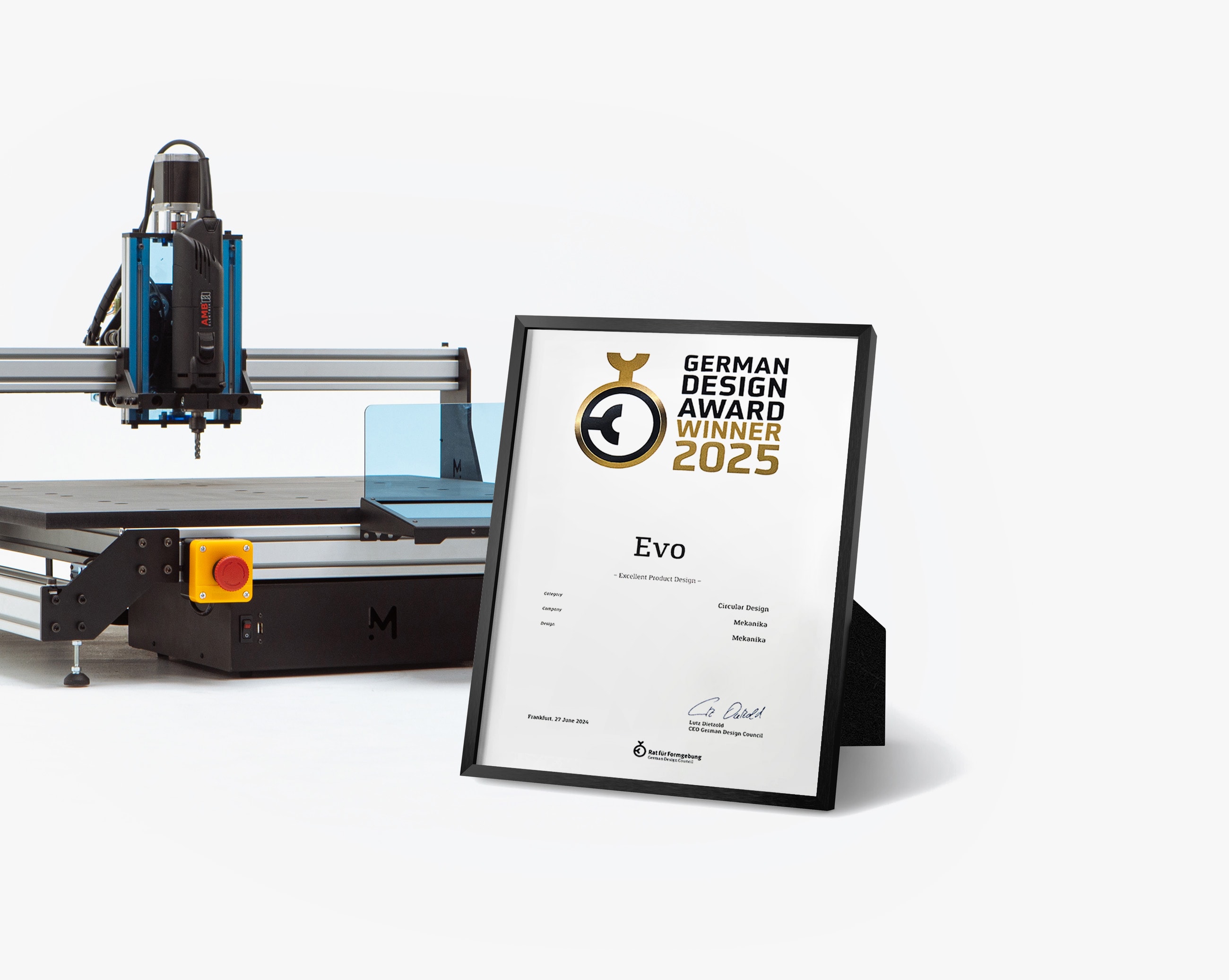 A German Design Award certificate framed in front of a Mekanika Evo CNC milling machine
