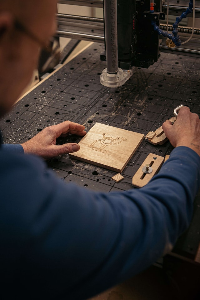Close up on Pierre Lohay 's machine while he is working on a cartoon engraving