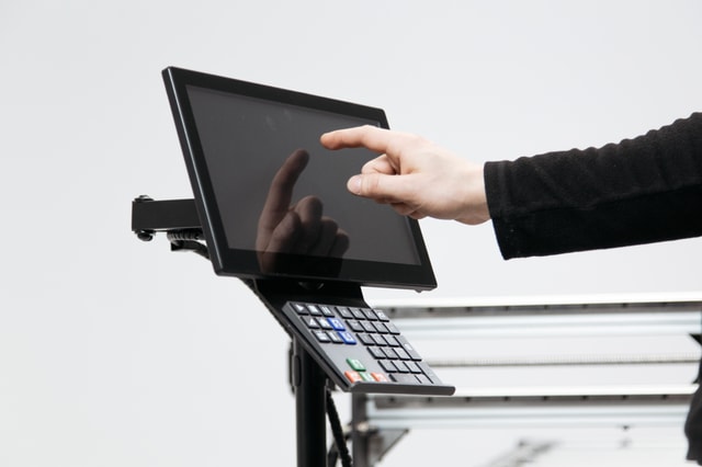A hand touching the expandable interface of the Mekanika Fab