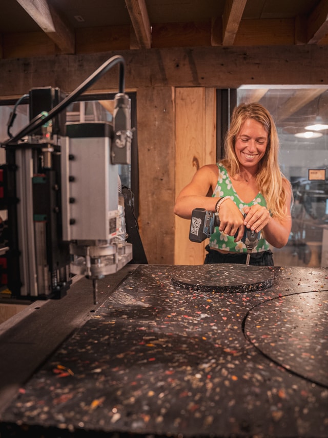 Regeneration Beach Attitude fixing recycled plastic panel on a Mekanika Pro CNC in the workshop