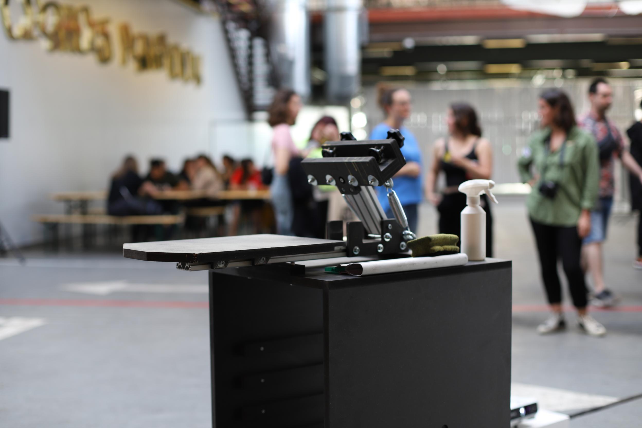The mekanika screen printing press setup in an open space for an event