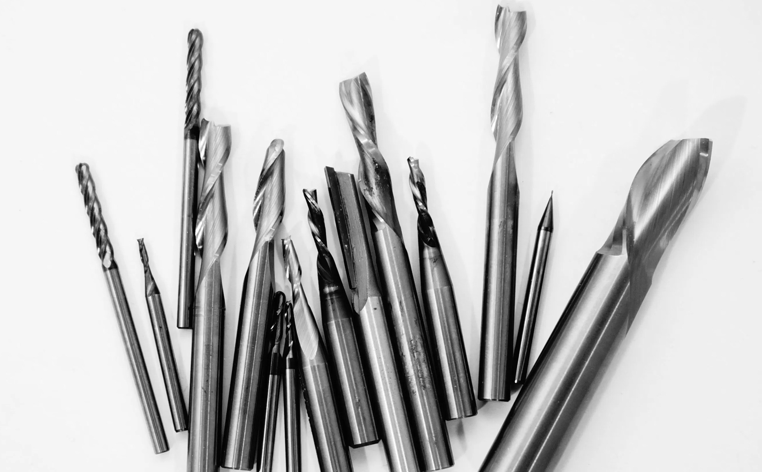 Some random carbide end mills on a white background.