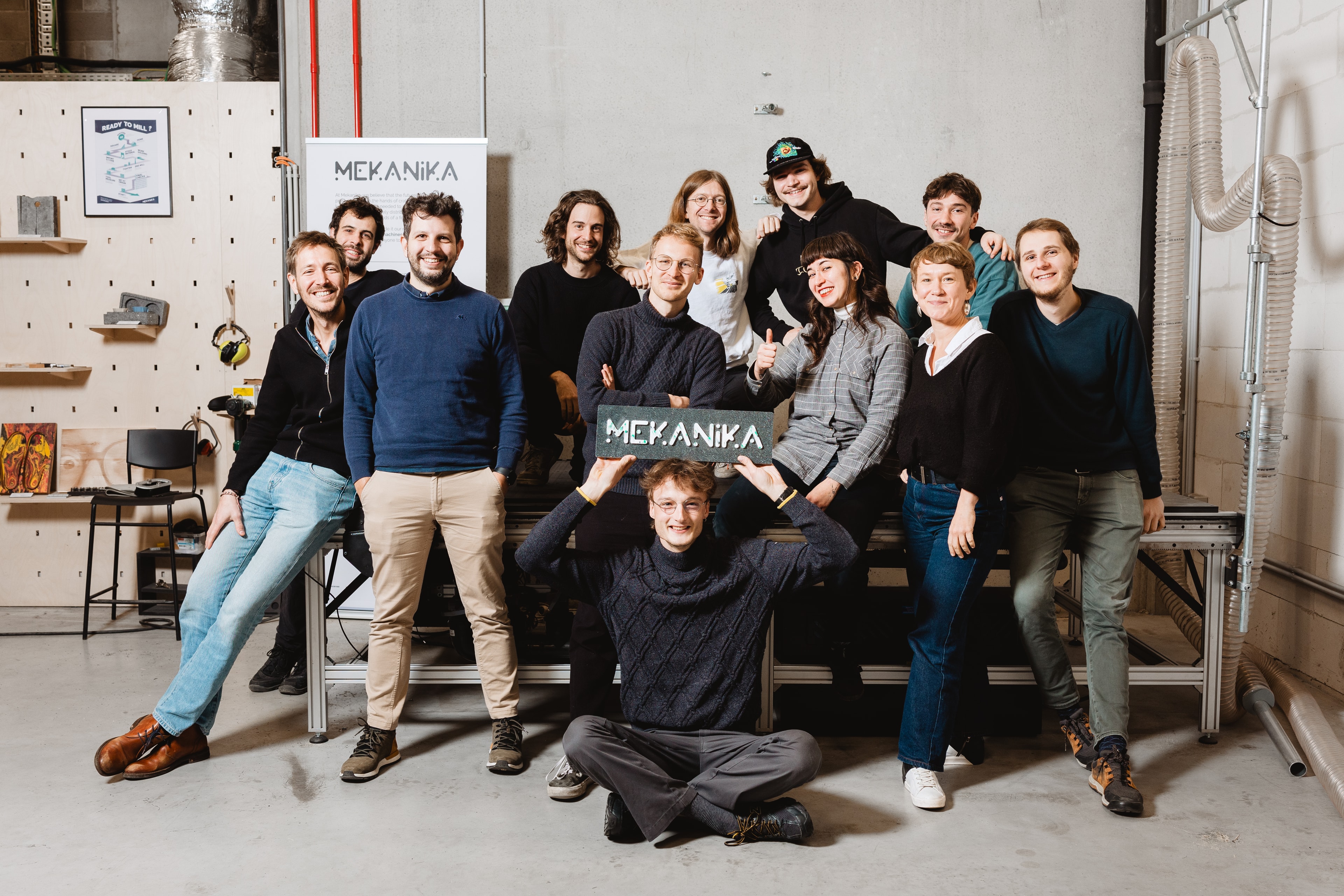 The mekanika team next to the Mekanika Fab CNC milling machine