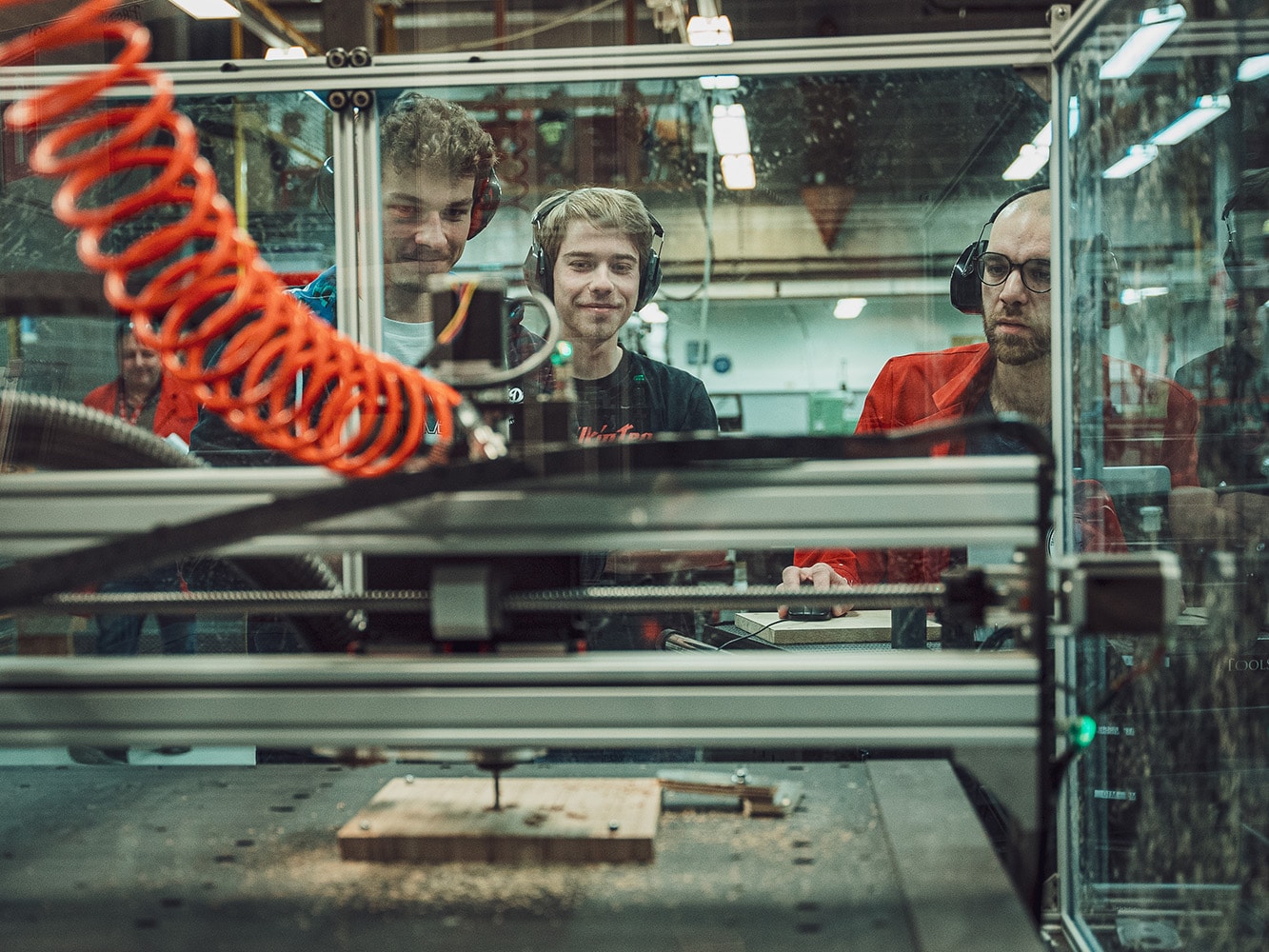 Two people working on a Pro CNC at ECAM 