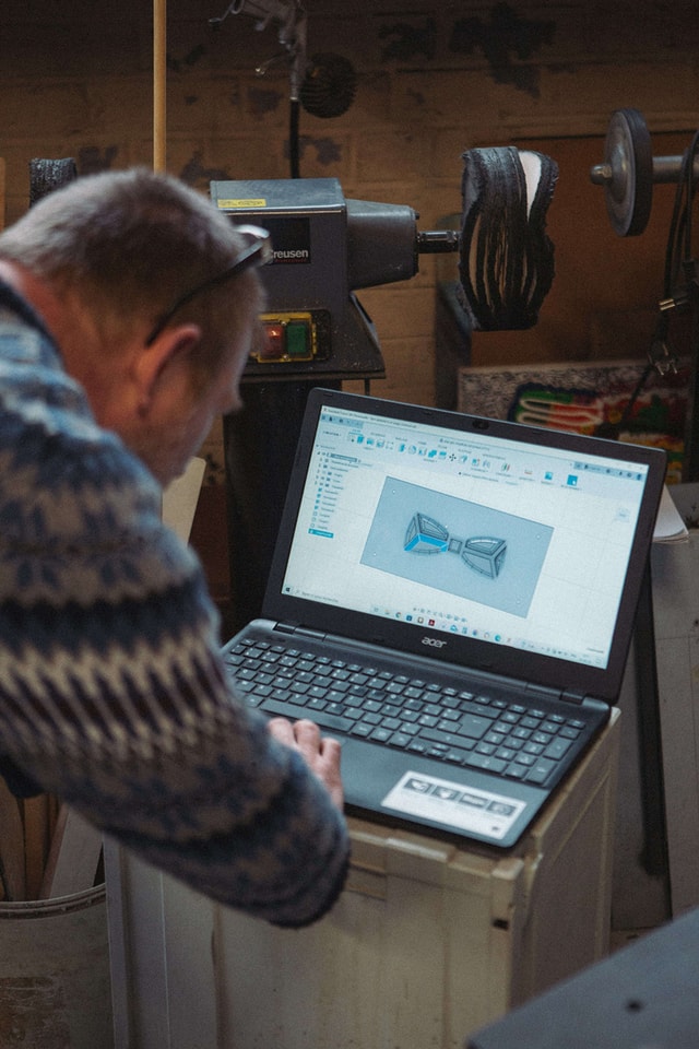 Michel preparing the 3D model of a bowtie on his laptop