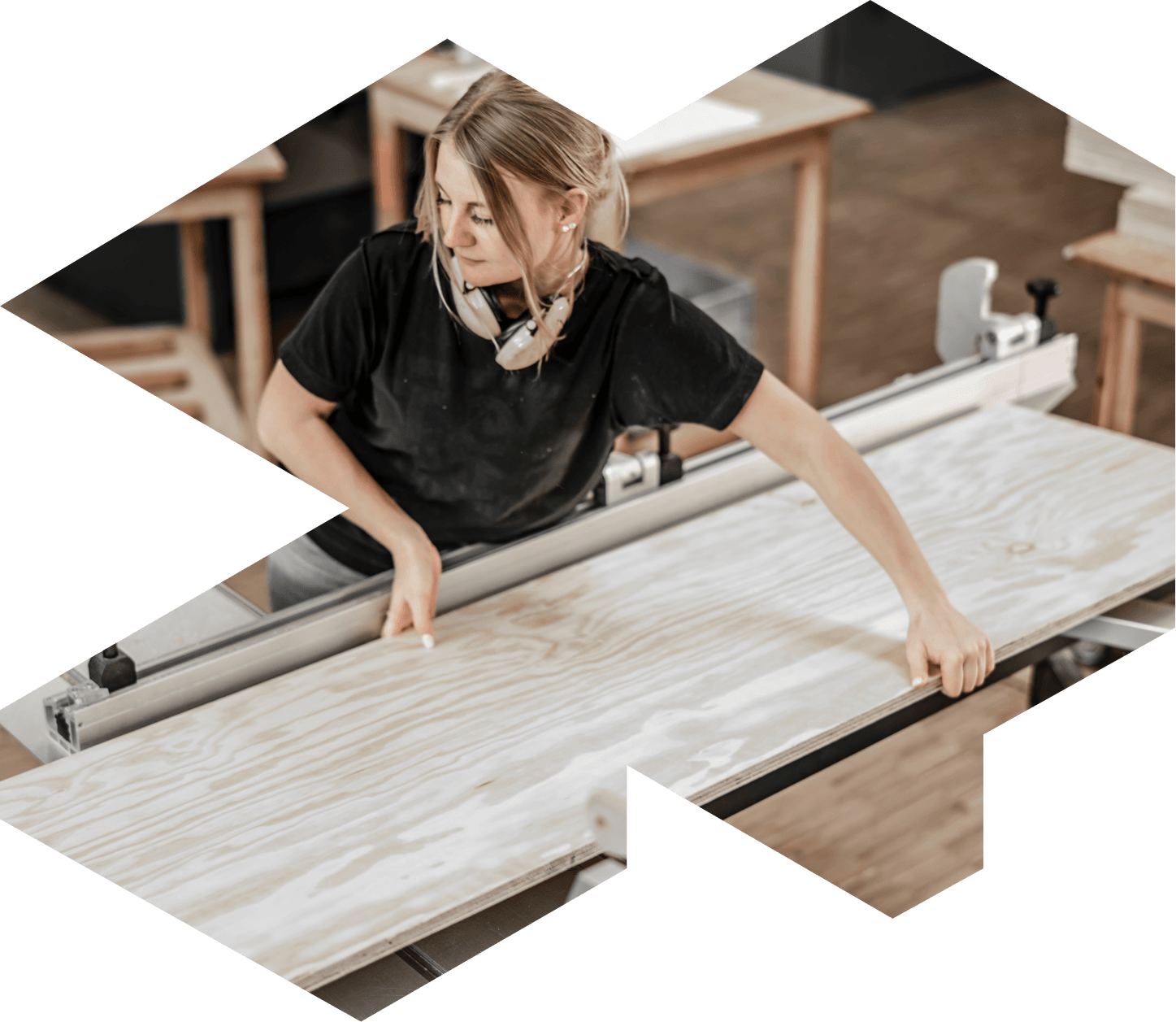 Woman carpenter holding a wood panel 