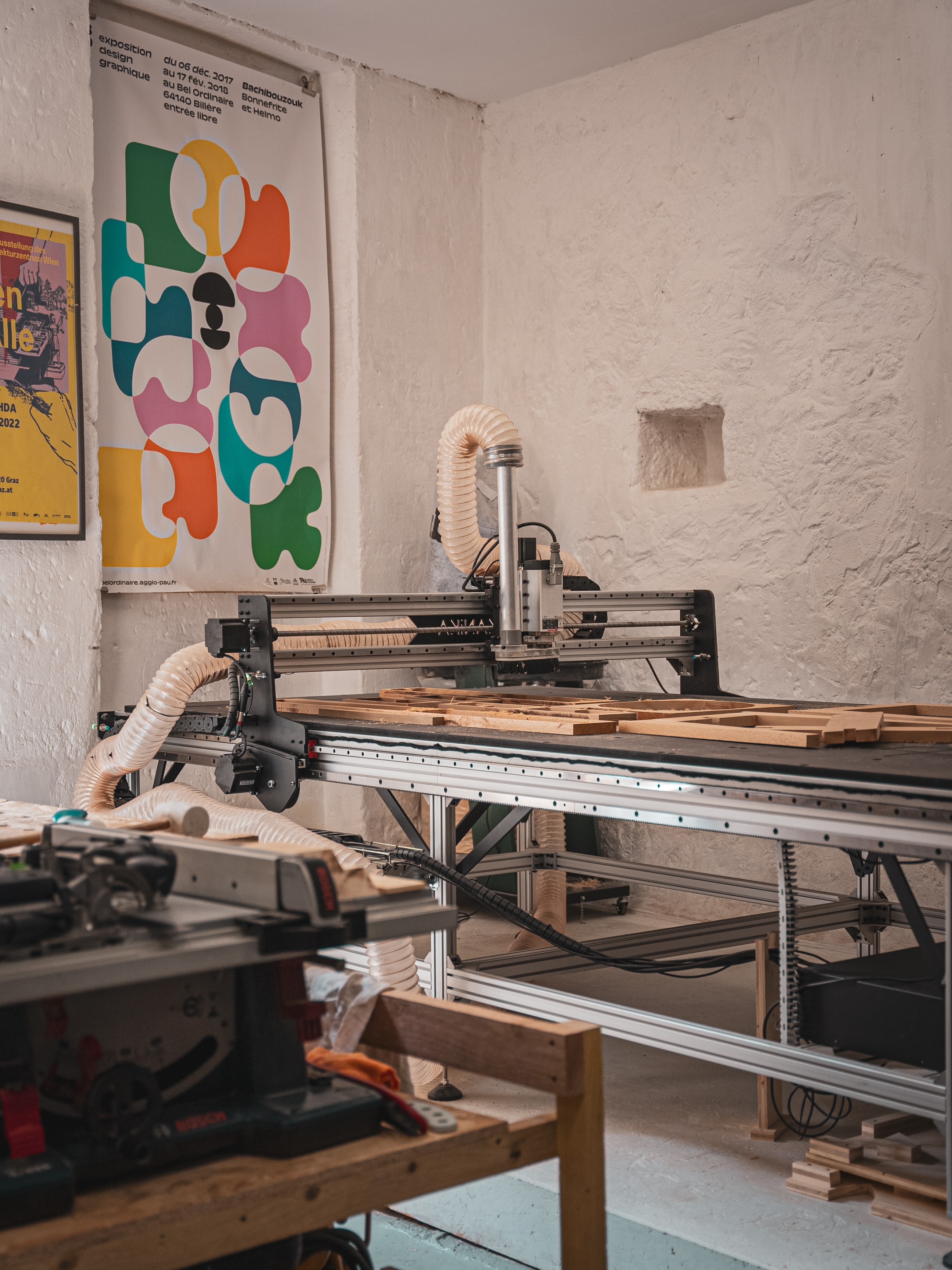 Mekanika Fab CNC milling machine milling wood parts in a decorated woodworker's workshop