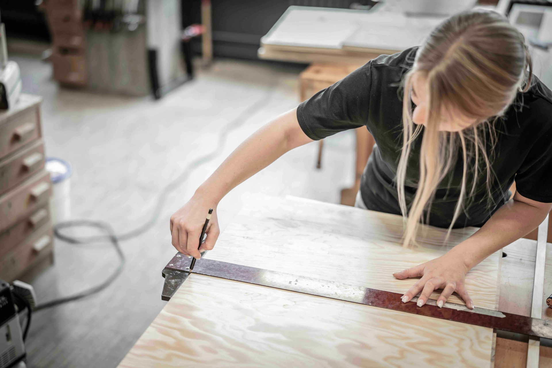 Joiner Measuring a Wood Panel
