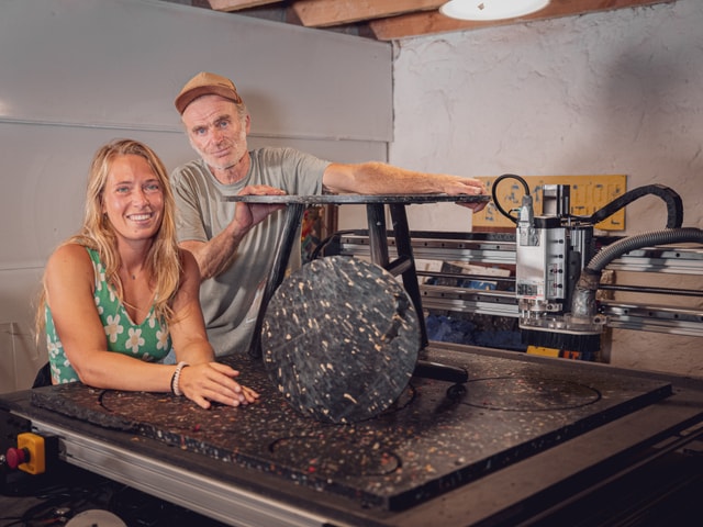 Regeneration's team with a recycled plastic table in their workshop