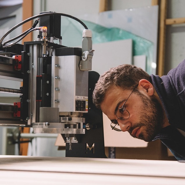 Someone checking the VFD Spindle on a Mekanika Fab CNC milling machine