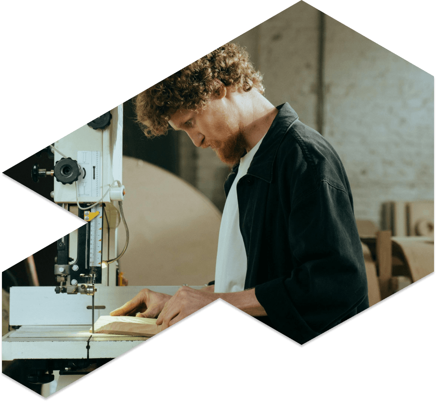 Creator cutting wood on his workshop