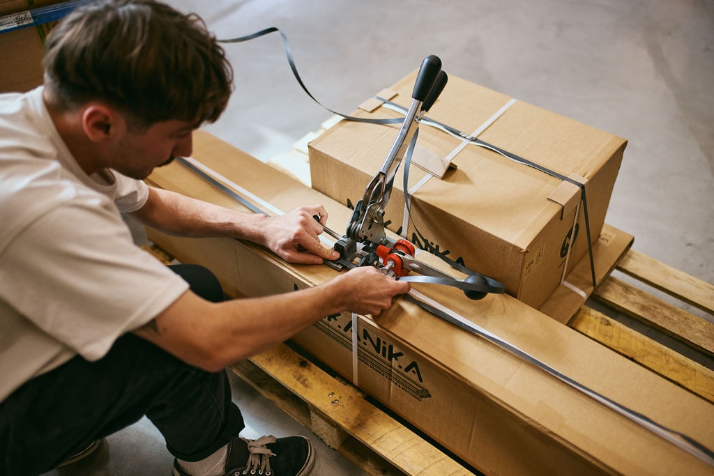 Two Mekanika boxes on a pallet being prepared for delivery