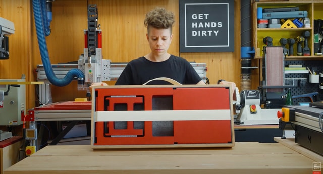 User holding her foldable stools and table made on Evo