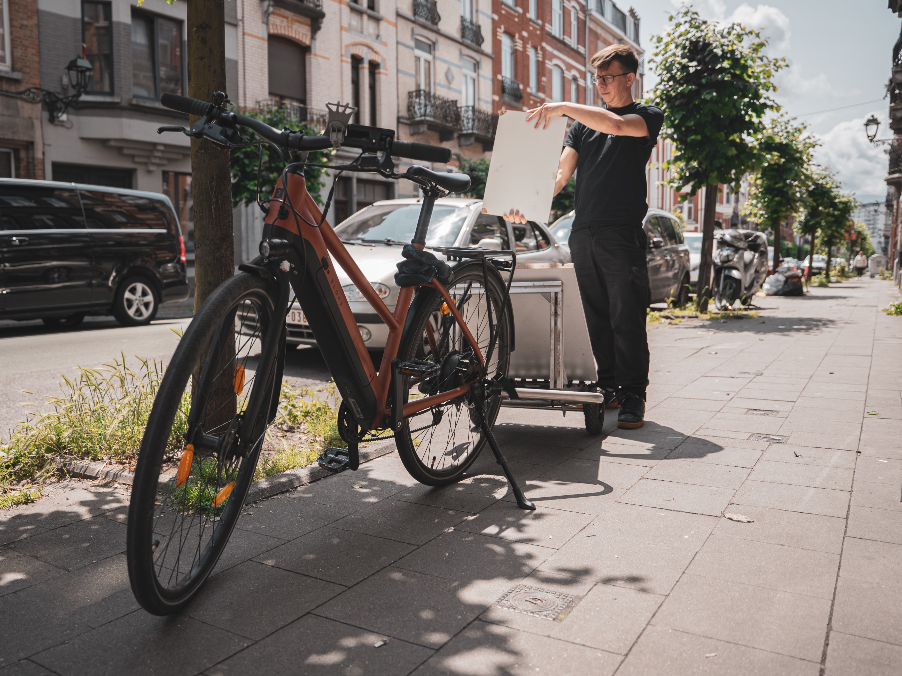 Joanie Lemercier picking up a panel found in the street
