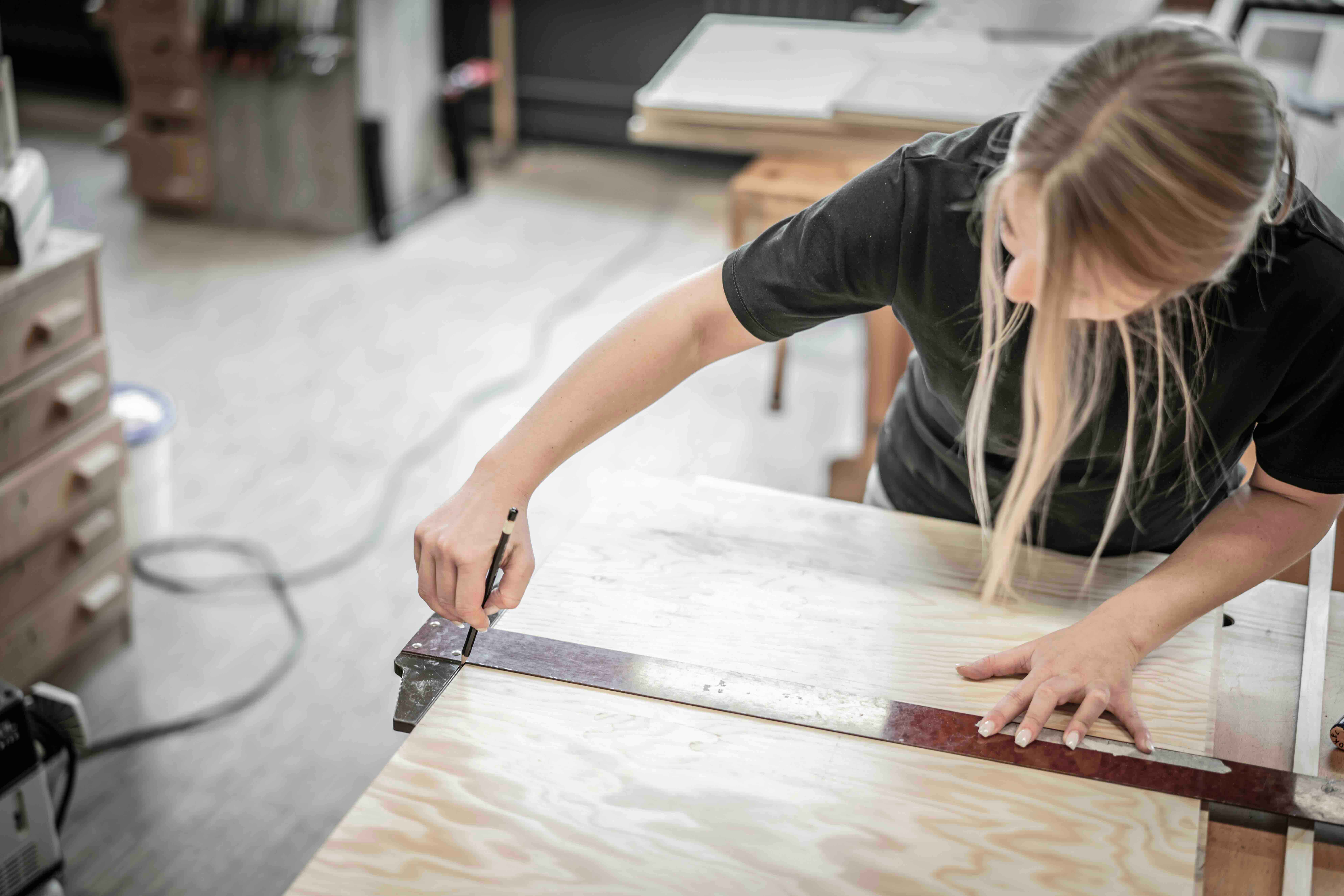 Joiner Measuring a Wood Panel