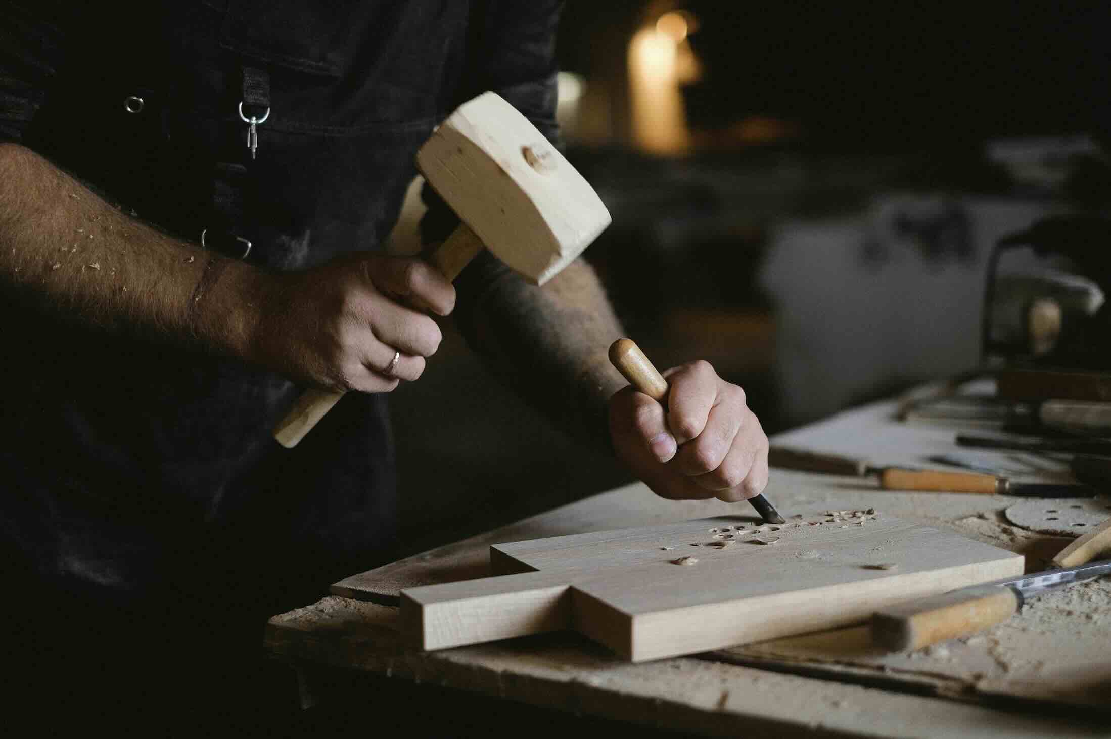 Zoom on a craftsperson sculpting wood